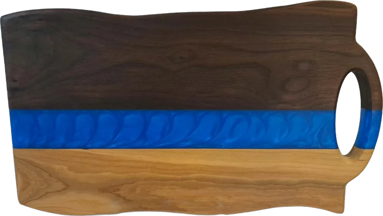Walnut and cherry board with a blue pearl resin river and a round handle